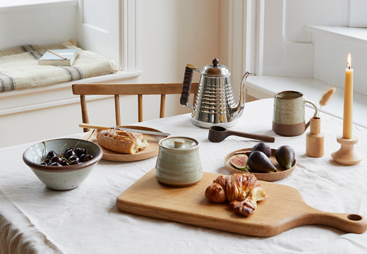 a weekend breakfast table with coffee and croissants