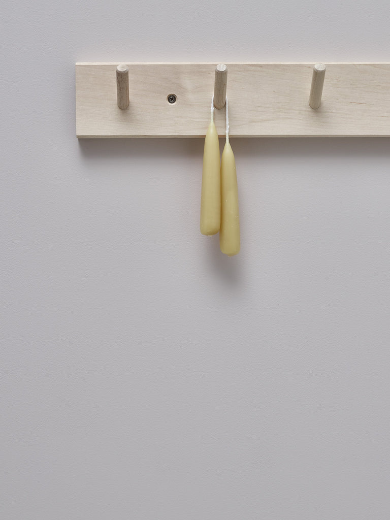 Set of two hand-dipped beeswax stubby candles hanging by wick