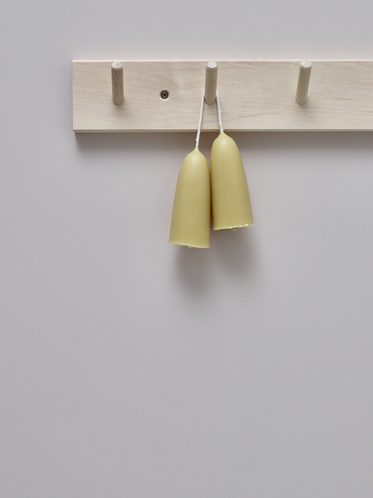 Two hand-dipped stumpie beeswax candles connected by their wick