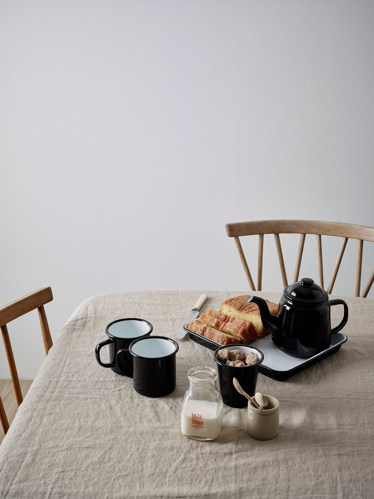 Breakfast scene on simple beautiful table with black enamel  homeware selection