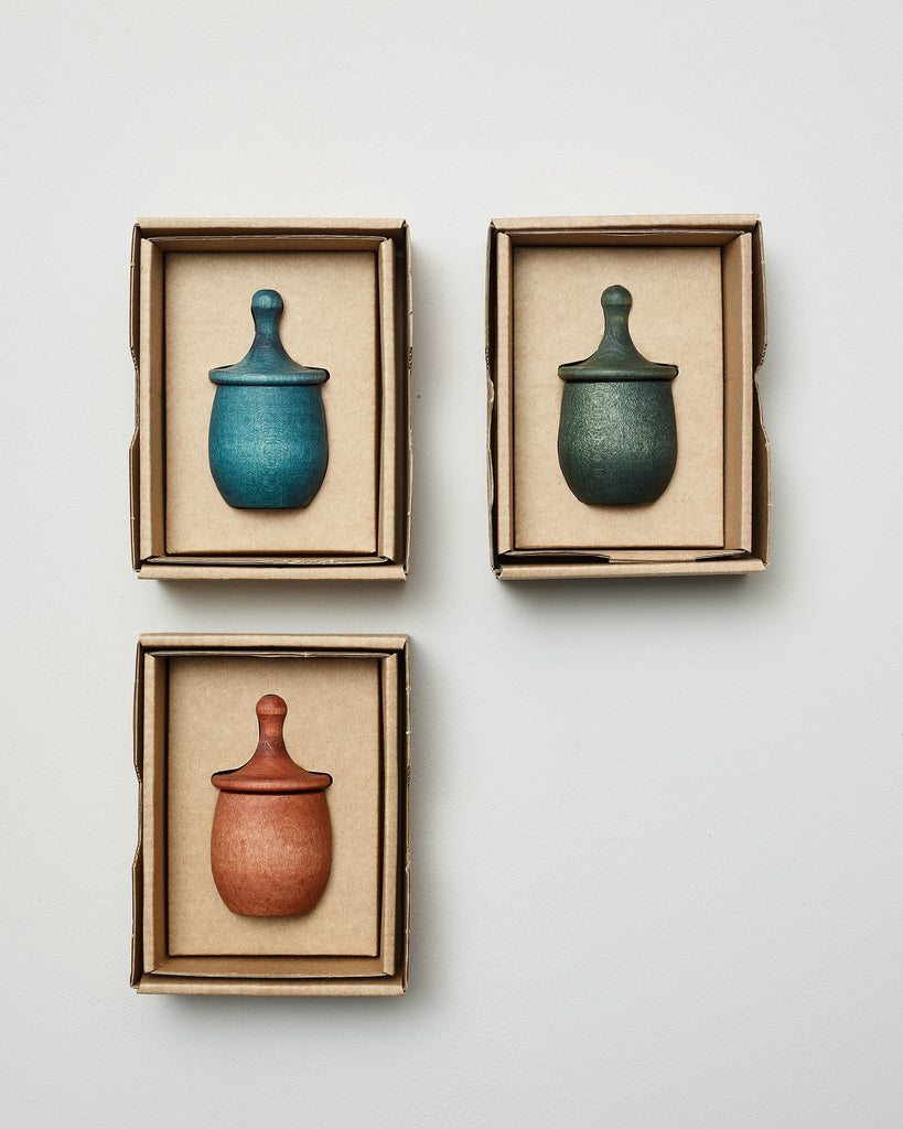 Selection of three eco-friendly Grapat wooden little thing spinning top toys in their beautiful boxes