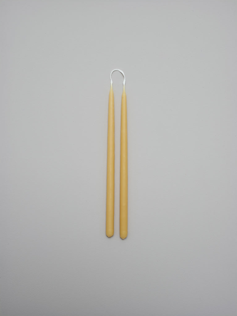 Two thin tapered hand-dipped beeswax candles